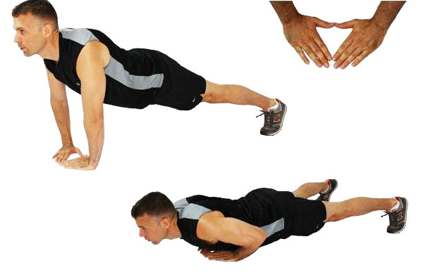 a man performing diamond push ups as part of his tricep workout without weights