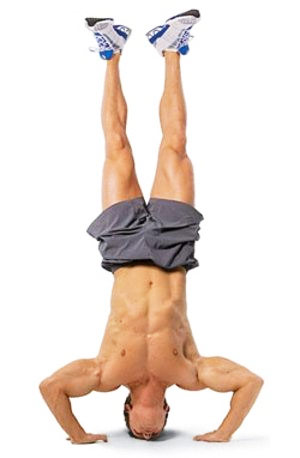 a man performing handstand push ups for his tricep workout without weights