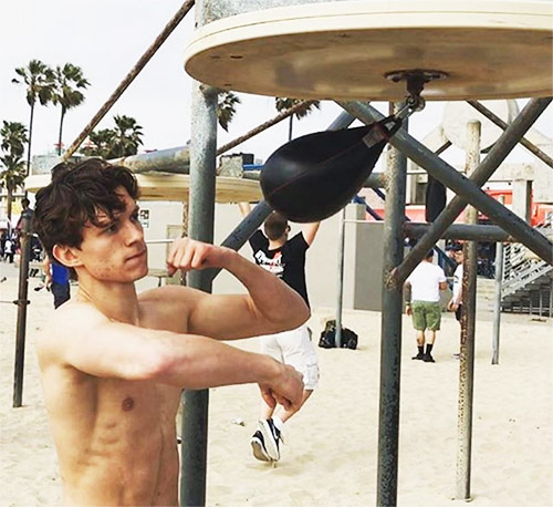 Tom Holland using a boxing speed bag as part of his spiderman workout
