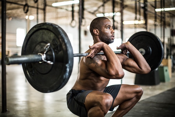 fit guy performing front squats