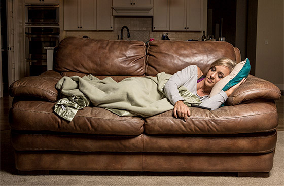 a woman sleeping on a couch