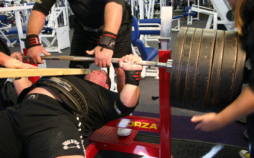 a powerlifter performing heavy bench presses