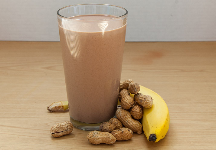 a chocolate protein shake with peanuts and a banana