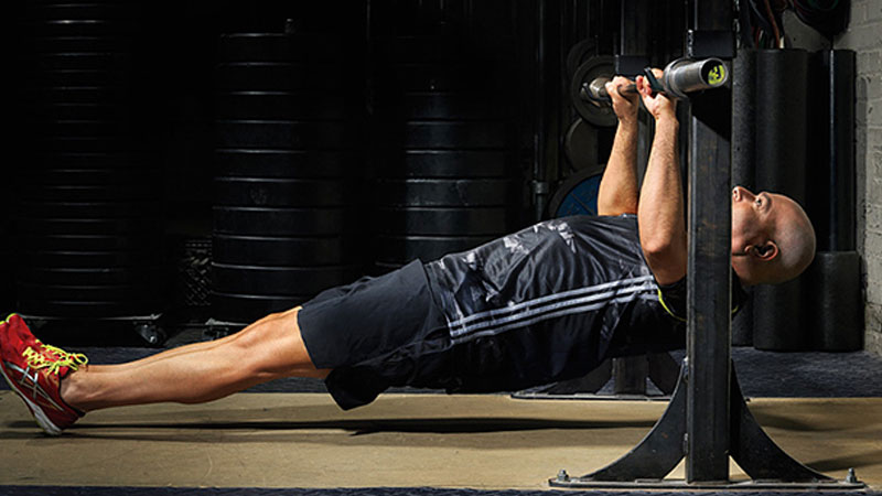 Man performing body weight inverted row getting big