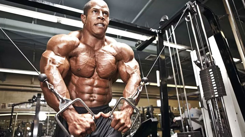 Bodybuilder in the gym overtraining on chest flyes