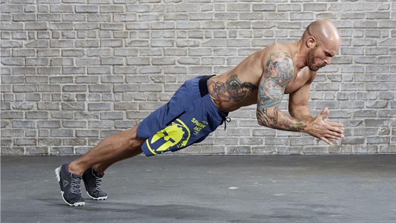 Male athlete performing contrast training method push-ups