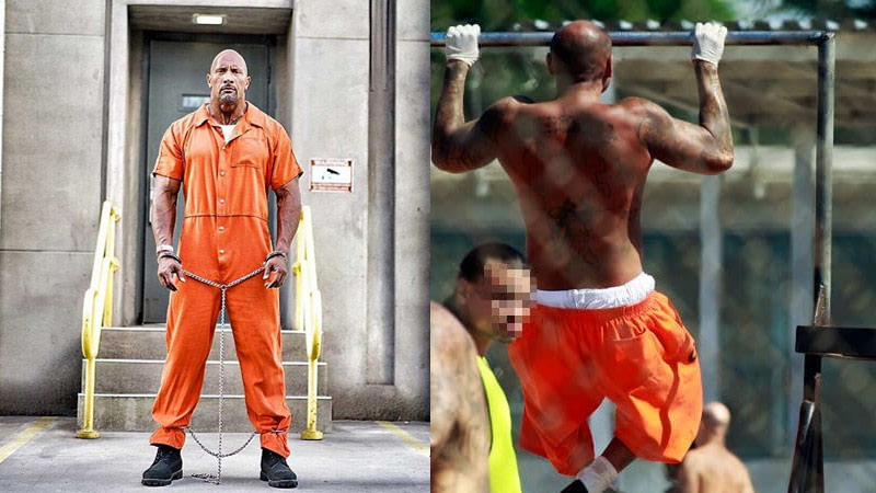 Dwayne Johnson in inmate uniform and inmate performs pull up