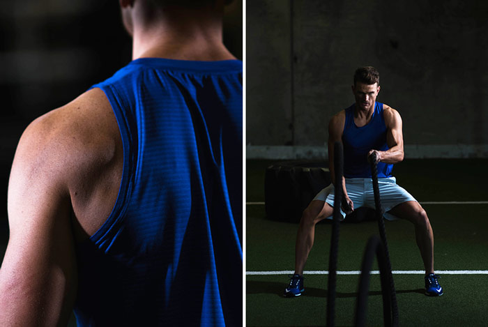 man using battle ropes whilst wearing tank top