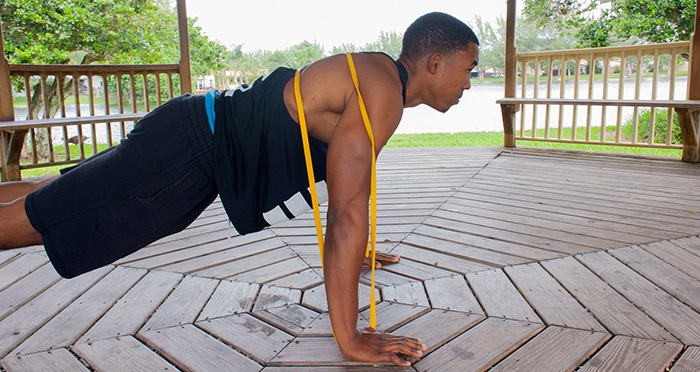 man doing resistance band push ups