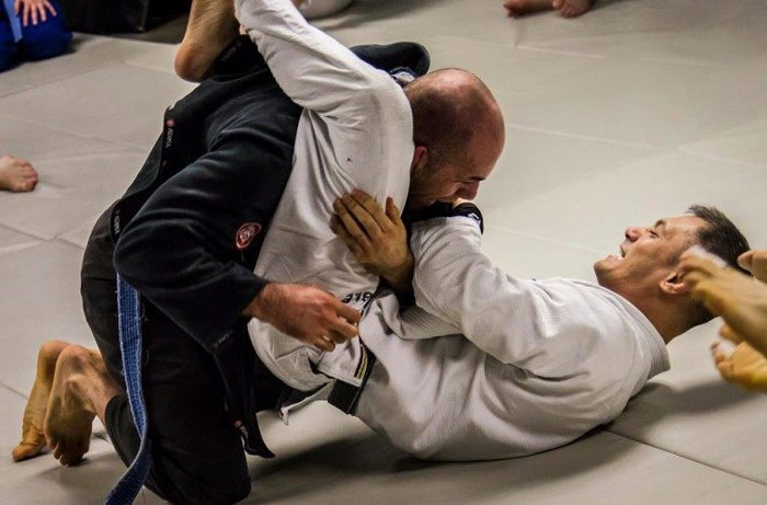 man sets up triangle choke