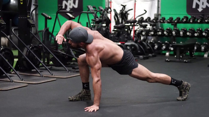 man performs mobility exercise for legs, shoulders and back