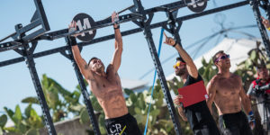 men perform pull ups in crossfit competition