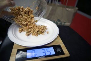 man places food onto scales
