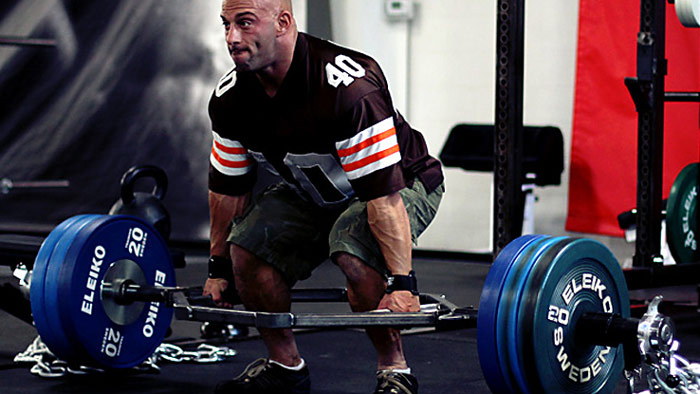 strength training athlete performs hex bar deadlift