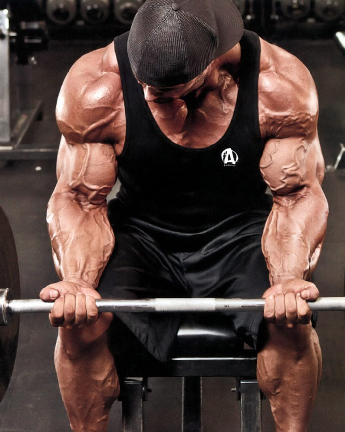 pro bodybuilder showing forearms