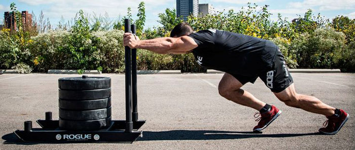 athlete uses prowler to develop explosive strength and power