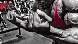 bodybuilder doing tricep pushdown as part of arms workout