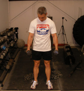 man showing standing dumbbell flexions and extensions of wrists