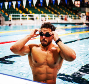 ross edgley showing muscular physique in pool