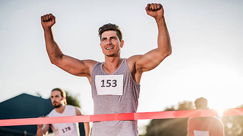 Man running past finishing line