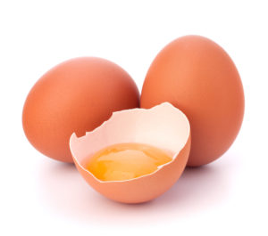Broken egg isolated on white background good fats to build muscle