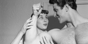 woman holding mans bicep