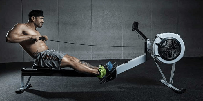 fitness athlete using row machine for low impact fat loss