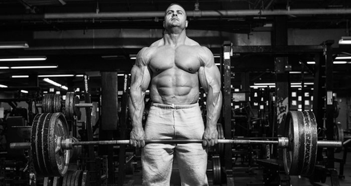 muscular bodybuilder working muscles with deadlift