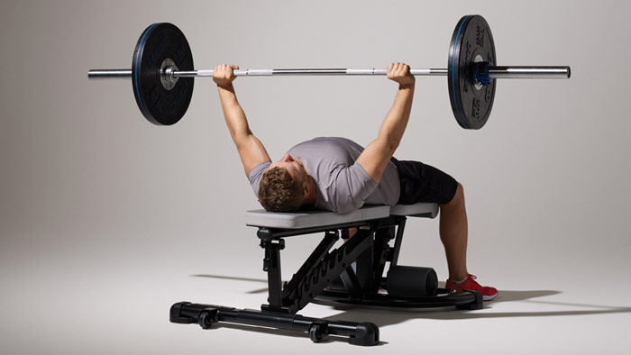 skinny guy performing bench press