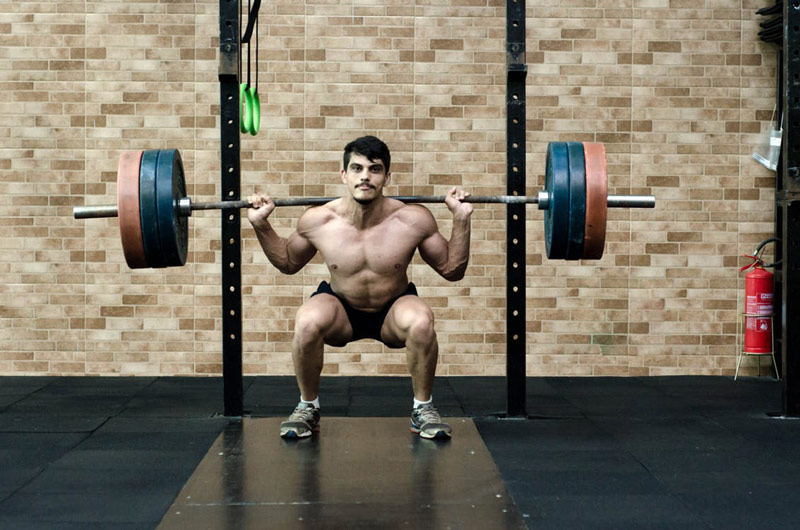 athlete performing squat as compound exercise