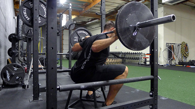 athlete performing box squat