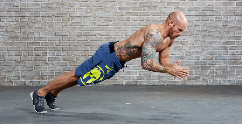 athlete performing plyometric push up for fat burning effect