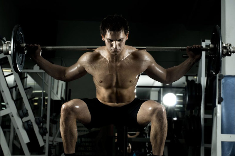 bodybuilder performing box squat