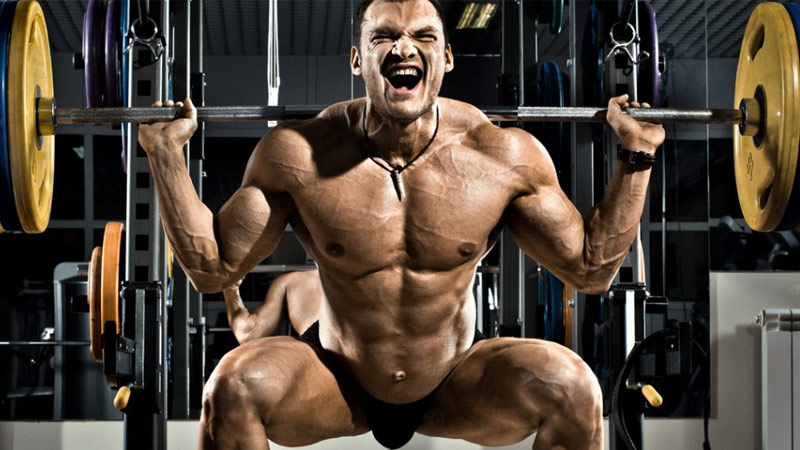 bodybuilder using squat for hypertrophy as part of German volume training program