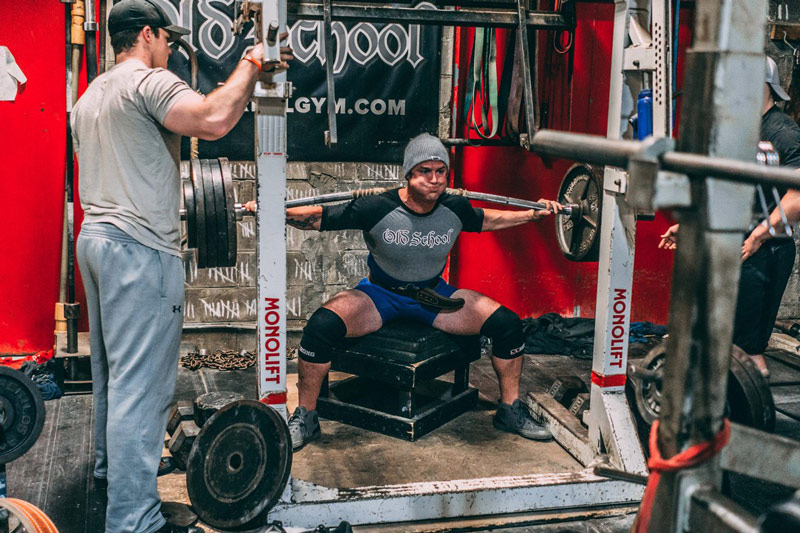 powerlifter performing box squat