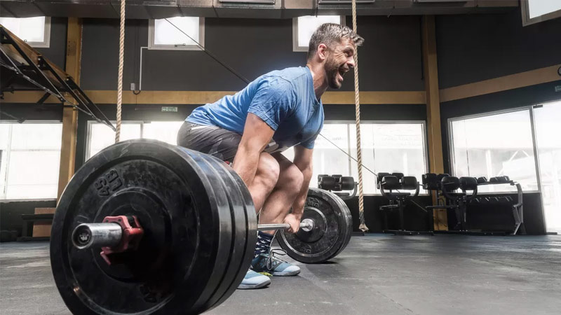 athlete performing deadlift as compound exercise