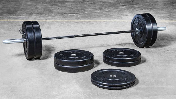 barbell and bumper plates being shown as essential piece of exercise equipment every home gym needs
