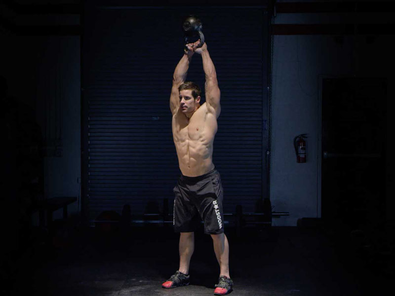 athlete performing kettlebell swings for fat loss