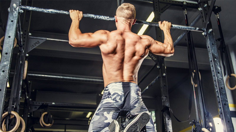 athlete performing wide grip pull up