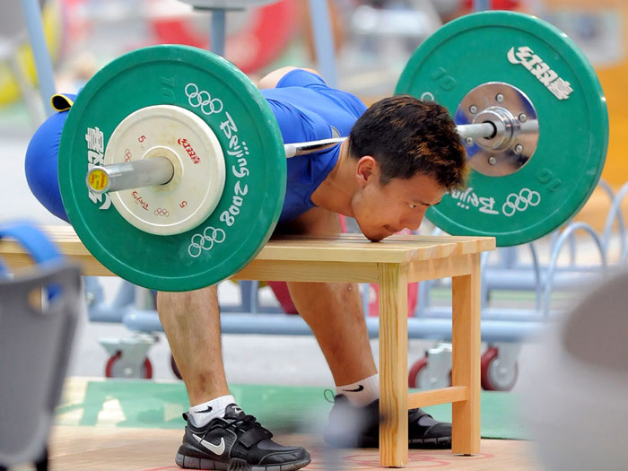 olympic weight lifter performing seated good morning variation