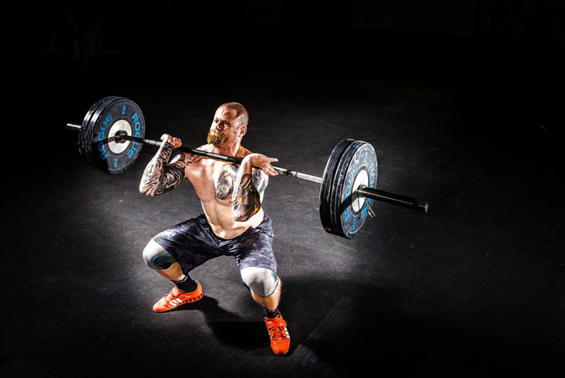 strong athlete performing power clean complex exercise