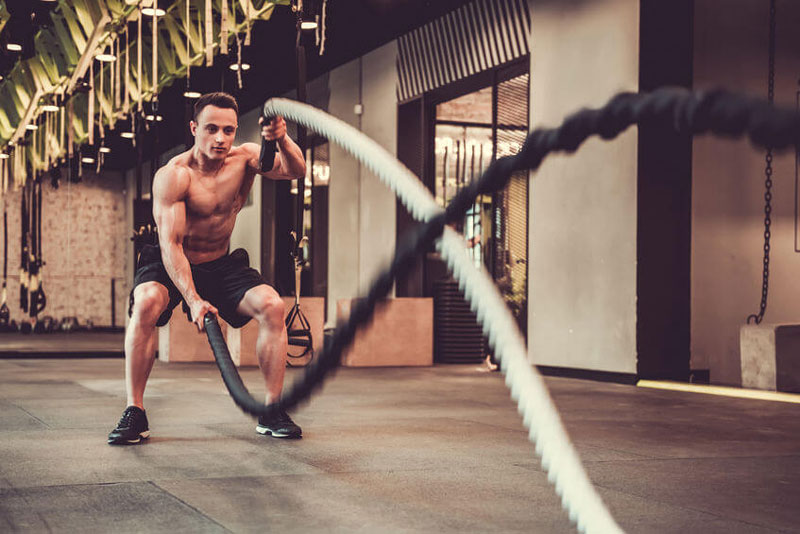 Muscular man using HIIT training for fat loss for a shredded six pack core