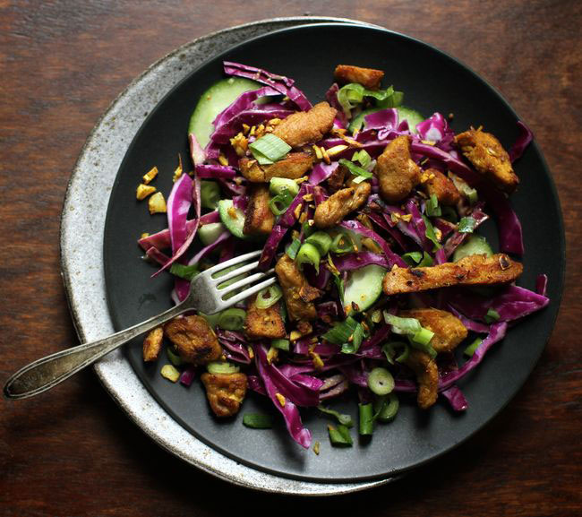 Red cabbage salad with curried seitan photographed in a bowl