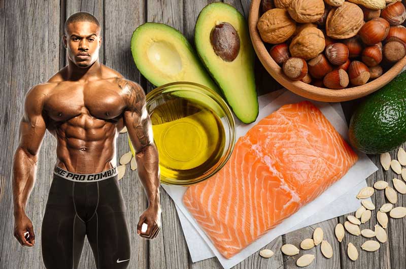 lean bulking bodybuilder stood next to selection of essential muscle building healthy fats