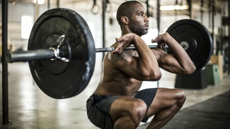 ripped athlete performing front squat