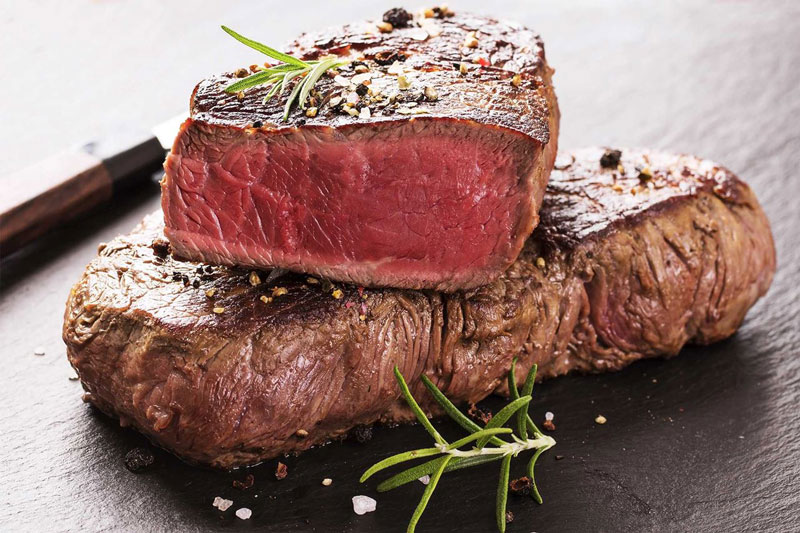 Fat burning grass fed steak cooked and placed on a chopping board