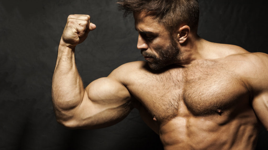 An image of a muscular man flexing his biceps to show testosterone function