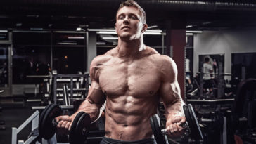 Muscular bodybuilder with size gained from muscle building meal plan