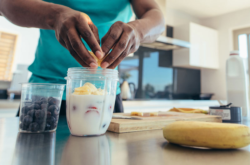 Athlete putting carbs into a protein drink