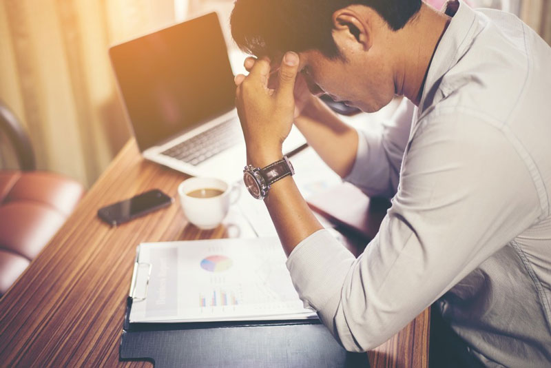 Man with low testosterone sat at desk